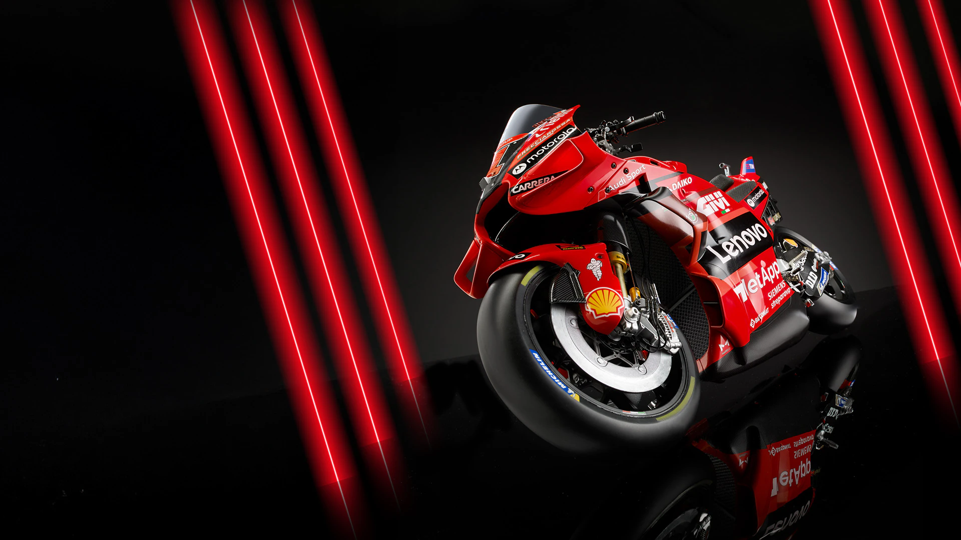 Obraz czerwonego motocykla Ducati na czarnym tle z czerwonymi neonami. Obraz zawiera tekst promocyjny: „Przesyłka 1 tylko za 4,98 zł”.